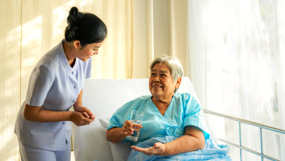 female caregiver smiling at an elderly woman