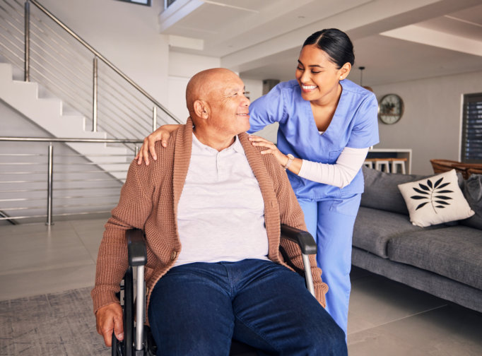 female caregiver smiling at an elderly man