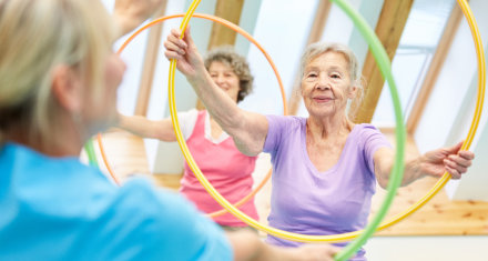 a senior working out using hula hoop