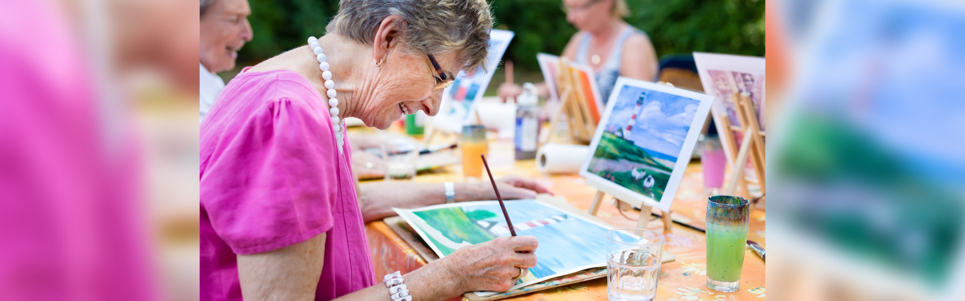 a senior woman doing painting