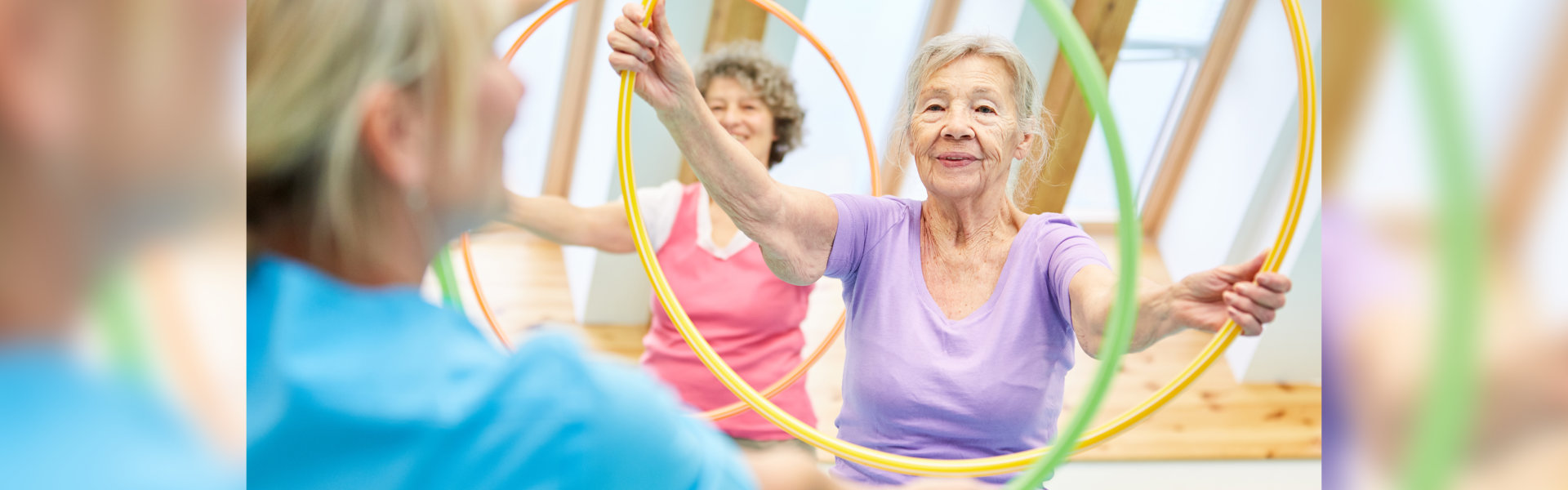 a senior woman working out using a hula hoop